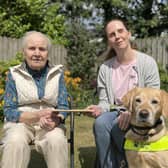Mirzda Oak, who celebrated her 100th Birthday handing over a donation to guide dog partnership Jo Toner and Emba. Pic Credit: Guide Dogs NI