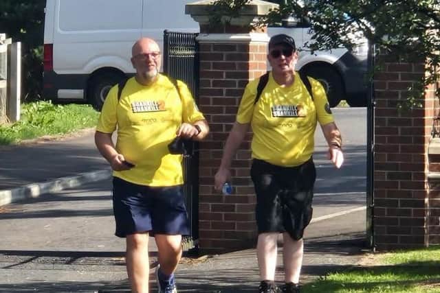 Archdeacon Mark Harvey (left) from Shankill Church of Ireland Parish walked 130 miles over nine days, seen here with one of the many suporters who joined him for parts of the walk.