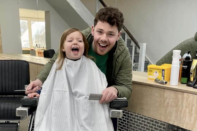 Roger Mulholland, owner of the new Craft Barber's Shop in Bridge St Portadown, Co Armagh, with his daughter Matilda.