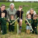 Pupils from Naiscoil Na Banna and St John the Baptist Primary School helping to plant some of the trees between Churchill Park and the River Bann. Also included are adults, from left Shauneen McGeown, deputy leader, Elaine Sterritt, parent, and Erin Kelly, teacher. PT17-201. Picture: Tony Hendron