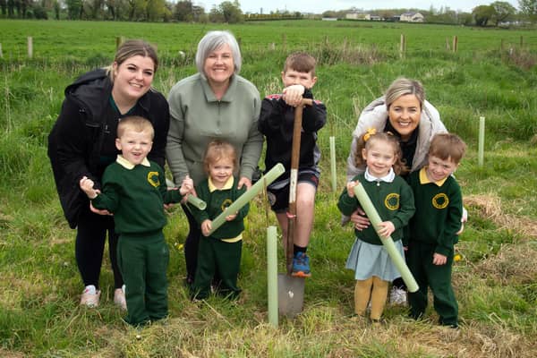 Pupils from Naiscoil Na Banna and St John the Baptist Primary School helping to plant some of the trees between Churchill Park and the River Bann. Also included are adults, from left Shauneen McGeown, deputy leader, Elaine Sterritt, parent, and Erin Kelly, teacher. PT17-201. Picture: Tony Hendron
