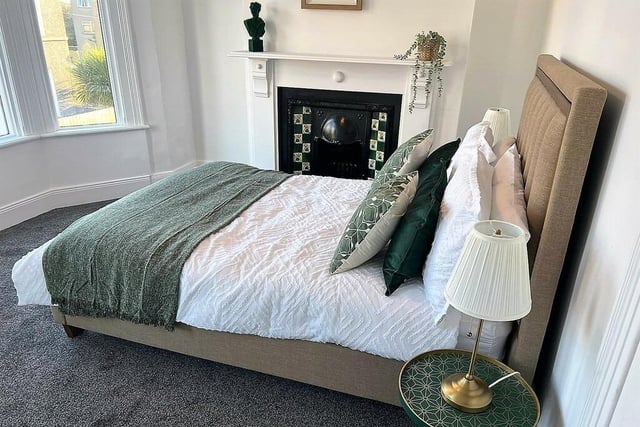 Front bedroom with feature original fireplace and bay windows.