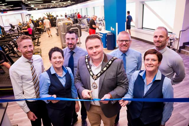 Cllr Mark Cooper cuts the ribbon to officially open Antrim Forum’s Fitness Suite, alongside members of the Leisure Team and Cllr Paul Dunlop. Pic: Antrim and Newtownabbey Borough Council).