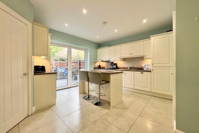 The kitchen has an excellent range of eye and low level units, island with breakfast bar seating, stainless steel sink unit, electric hob and oven, stainless steel extractor fan, integrated dishwasher, integrated fridge freezer, recessed lighting, and has part-tiled and a fully-tiled floor.