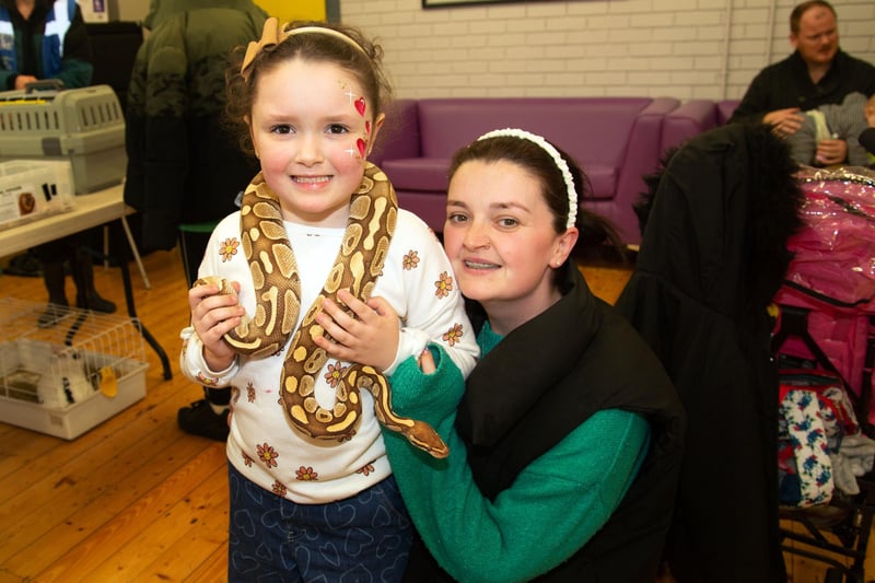 Autumn McKeever tries on a snake for size at the petting farm during the Park Road and Obins Street St Patrick's fun day on Saturday. Mum Aine was on hand to lend support. PT11-222.