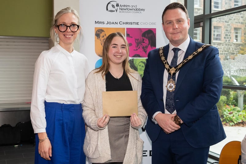 Anna Stitt, Volunteering Bursary Award winner, pictured with Mayor of Antrim and Newtownabbey, Councillor Mark Cooper BEM and chair of the bursary panel, Harriett Roberts.