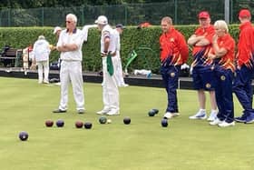 Sam McCombes, Lurgan A Skip consulting with his team while Luke Donaldson checks the rink scores
