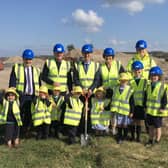 Dr Mark Browne, Permanent Secretary at the Department of Education, cutting the first sod on a new 14 class primary school and double nursery unit for Mill Strand Integrated Primary School. Pictured with Dr Browne are Principal, Philip Reid, Chairperson of the Board of Governors, Louise Rossington, representatives from Lowry Building & Civil Engineering Ltd and pupils from Mill Strand Integrated Primary School.