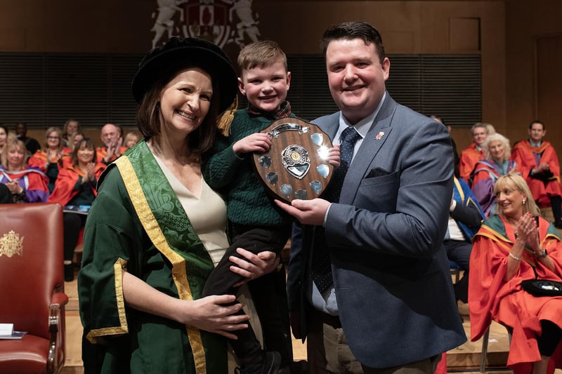 University Provost Cathy Gormley-Heenan presents the Ulster University's Convocation Postgraduate Student of the Year award to Máirtín Mac Gabhann at the Ulster University Winter Graduation Ceremony at the ICC, Belfast. Pictured holding his dad’s award is Dáithí Mac Gabhann.
