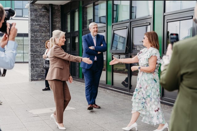 Sinn Fein Upper Bann MLA John O'Dowd looks on as First Minister Michelle O'Neill is welcomed to the official opening of Lismore College by principal Mrs Shauna Lennon.