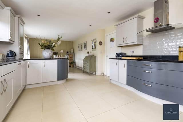 The kitchen / dining area has an extensive range of high and low level kitchen cabinets, including display cabinets with glazed panel.