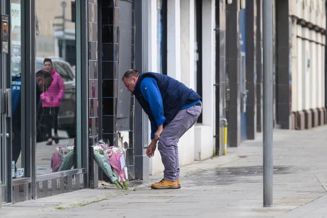 Members of the public have been laying flowers at the scene of yesterday's collision in the High Street area of Carrickfergus. Photo: Pacemaker Press.