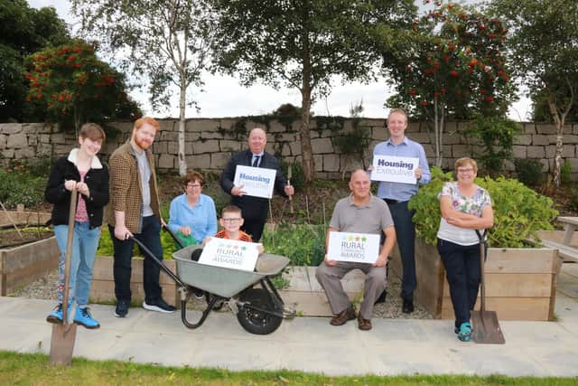 Moneydarragh Community Hub Winners of the 2022 Rural Community Award along with the Housing Executive launch the 2023 Rural Community Awards l-r Claire Mooney Artist and Ffcilitator, Ruairí Jordan Marketing and Communications, Marian Fitzpatrick Committee, in wheelbarrow Oisín Collins, Liam Gunn South Down Area Manager, Hugh Cox Vice Chair Moneydarragh Community Hub Committee, Tim Gilpin Rural and Regeneration Manager and Marian Cox Committee. Credit NIHE