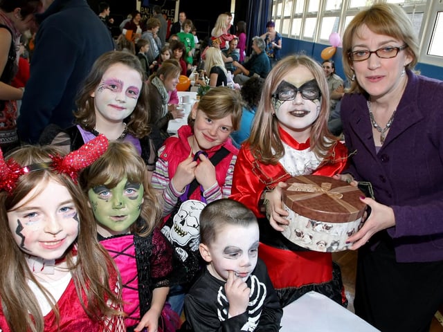 Principal Mrs Diana Evans pictured along with children in fancy dress at Ballycastle Integrated PS Halloween Coffee Morning in 2019.