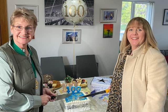 Patricia Perry, High Sheriff of the County of Antrim and past district chairman Inner Wheel Ireland, and Mary Carmichael, president of Larne Inner Wheel Club, cutting the anniversary cake. Photo submitted by Larne Inner Wheel Club