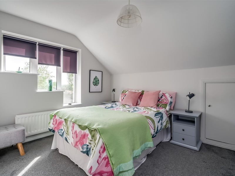 Bedroom with access to under eaves storage.