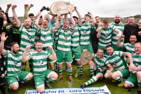 Cleary Celtic captain Shay McAllister hoists the Mid Ulster Shield high after his side defeated Newry Celtic 2-0 on Easter Monday.