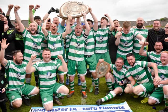 Cleary Celtic captain Shay McAllister hoists the Mid Ulster Shield high after his side defeated Newry Celtic 2-0 on Easter Monday.