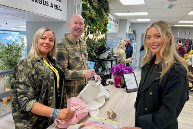 Miss NI Hannah Johns makes her purchase at the new NI Hospice shop in Carrickfergus. Also pictured are Carrickfergus Shop Volunteer Louise Lynn, and Christopher Griffin, Shop Supervisor.