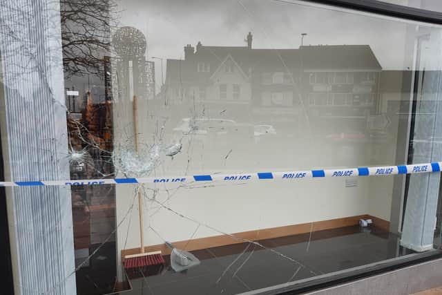 One of the shops which had its windows smashed on Sunday night.