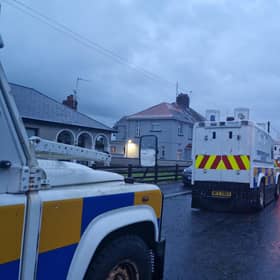 PSNI Land Rovers lined up and waiting in a side street off the Garvaghy Road in Portadown as protesters filled the road. They were protesting at the Parades Commission determination to permit Portadown Orange District to march through the Garvaghy Road.