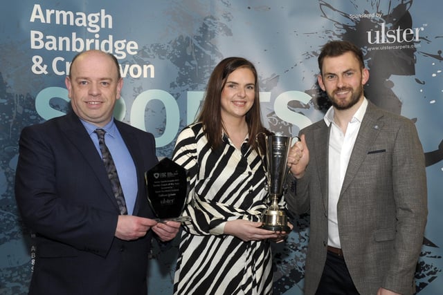 Vikki Grieve accepts the Senior Coach of the Year award on behalf of Callum Grieve, head coach of Craigavon Aztecs Volleyball Club. She is pictured with Richard Bullick (Sport Northern Ireland) and special guest Matthew Bell.