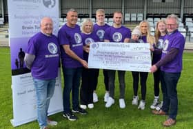 John and Joanne Annett and family hand over the donation to Brainwaves NI.