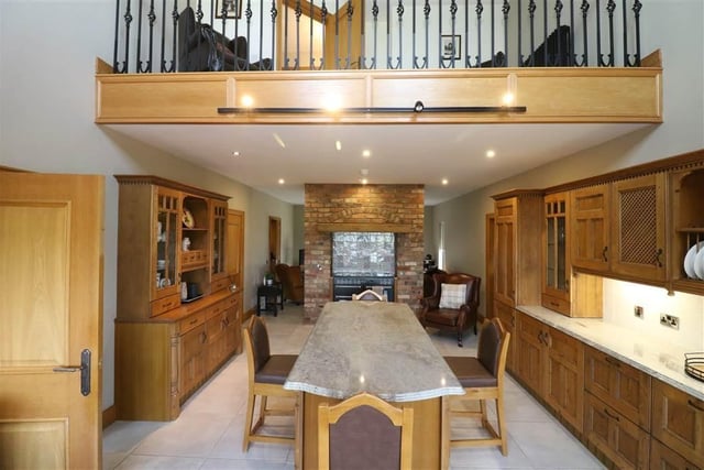 The beautiful kitchen is overlooked from a mezzanine on the first floor.