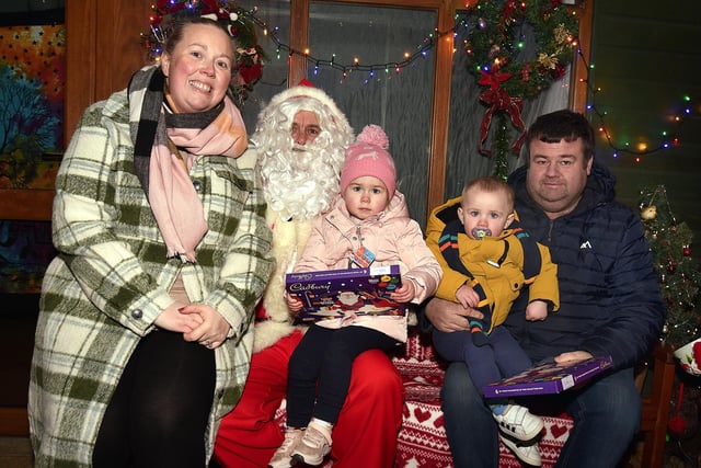 Pictured with Santa at the Richhill Christmas lights switch on are members of the McGeough family including, mum, Carrie and dad, Brian with children, Evie (2) and Joe (1). PT49-252.