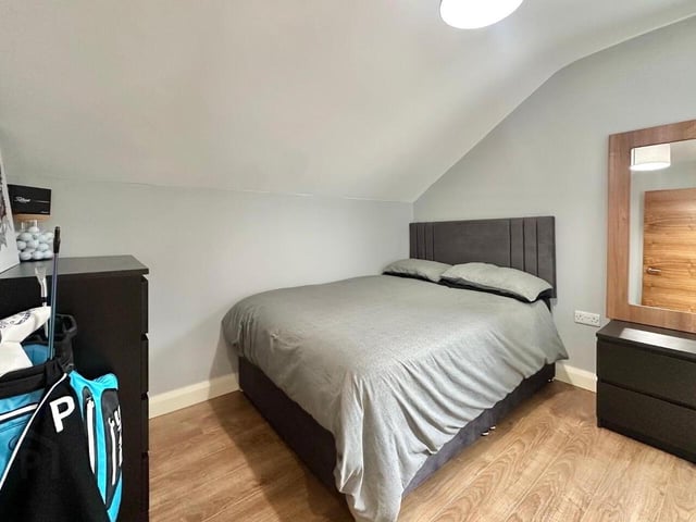 Bedroom with laminate wood floor.