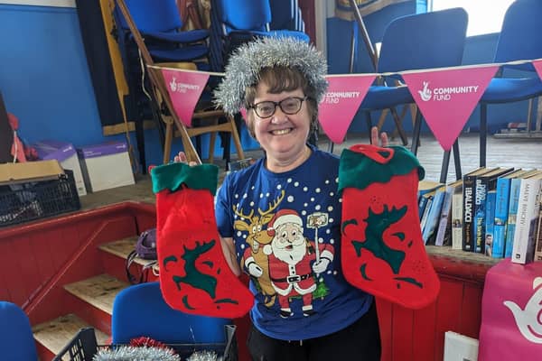 Tricia, organiser and Vice Chair of Friends of Castlecatt War Memorial Hall, with Christmas stockings. Credit National Lottery