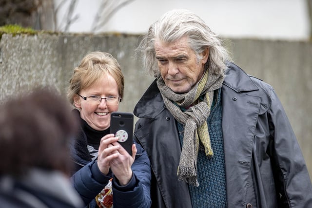 Pierce Brosnan was happy to pose for selfies during breaks from filming “Four Letters of Love” in Ballycastle on Tuesday afternoon