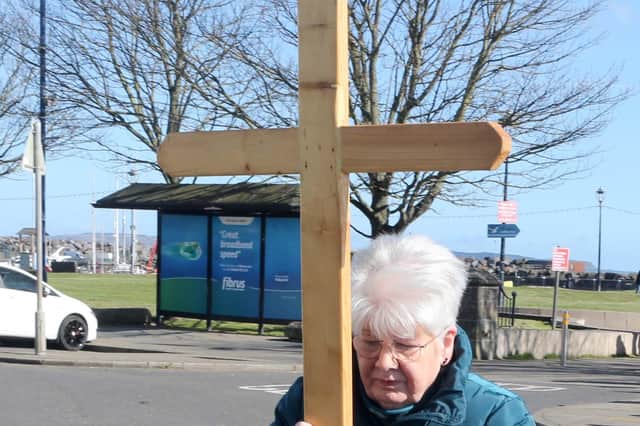 Christine Mitchell carrying the cross pictured at the Good Friday Walk of Witness. All photos by McAuley Multimedia