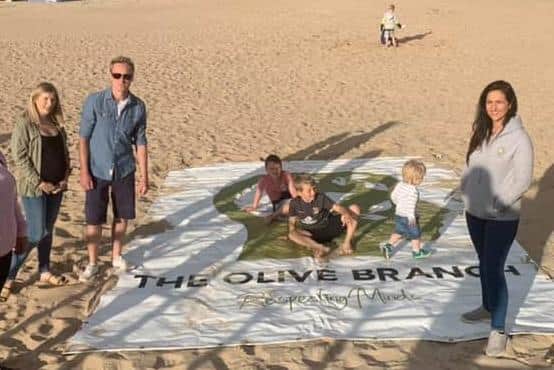 Coleraine man Adam Watson (second left) pictured during a beach walk he organised to raise funds for local mental health charity The Olive Branch. Adam has been awarded the BEM for services to Mental Health in the Farming Community in Northern Ireland. Credit Olive Branch