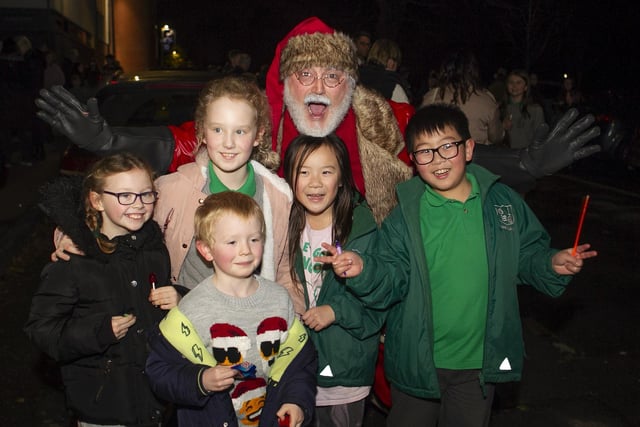 Santa poses for photo with young members of the Greenisland community.
