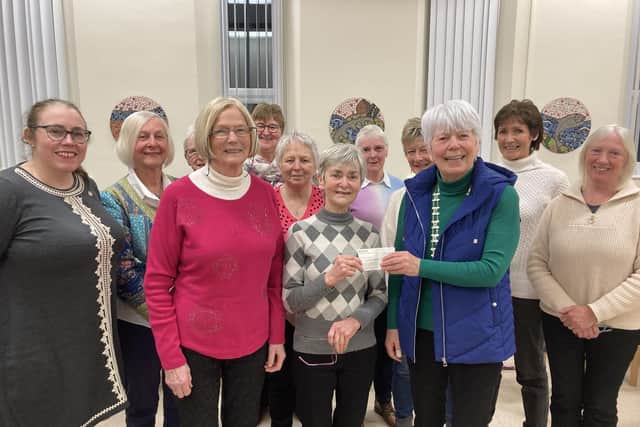 The business meeting ended with a presentation of a cheque for Marie Curie to Barbara Kerr who is a member of Ballycastle Branch of Marie Curie. Face masks had been worn throughout the meeting and were removed for a photograph.