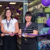 Menarys manager, Lynette Young, centre, cuts the ribbon to officially open the company's new Lurgan store with the help of sales assistants, Shirley Graham, left, and Sharon Kelly. LM18-204.