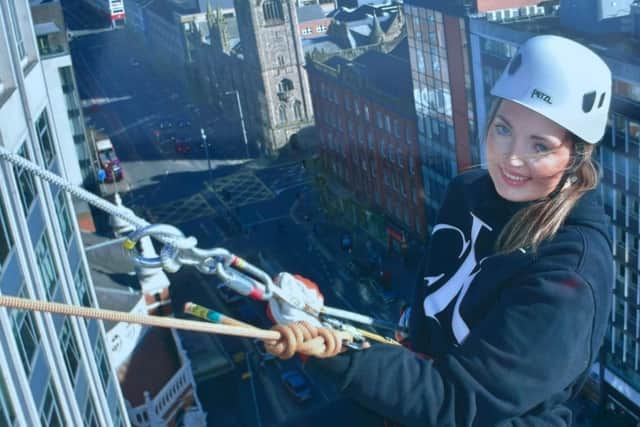 Crumlin woman Emma Adair abseiled down the Europa Hotel to raise money for Muscular Dystrophy UK. Pic credit: Muscular Dystrophy UK