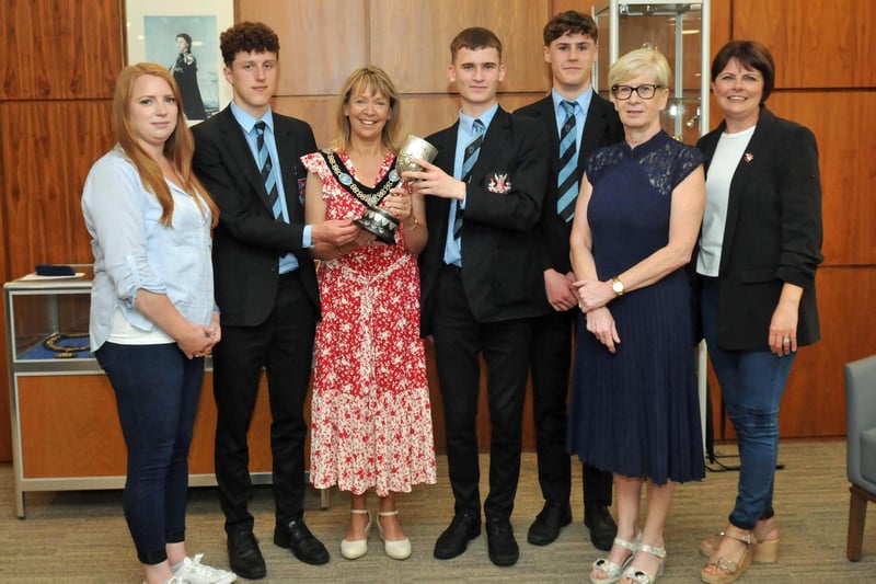 Lord Mayor of Armagh City, Banbridge and Craigavon, Councillor Margaret Tinsley is shown the Taylor Cup for Hockey won by Portadown College Boys Team. Included are team members, Harry, James and Oscar with coach, Mrs Rhonda Willis and Councillors Julie Flaherty and Kate Evans.