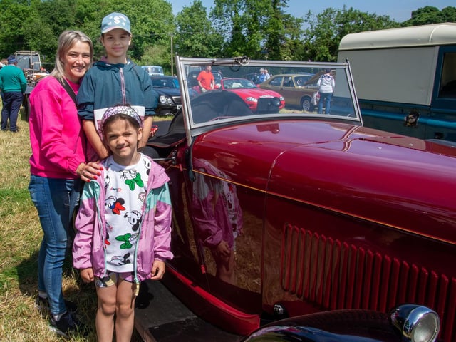 Posing with a 1931 Alvis 1250 vintage care at Drumcree Parish Garden Fete are, Lucy and children, Simona (9) and Borisa (7). PT23-228.