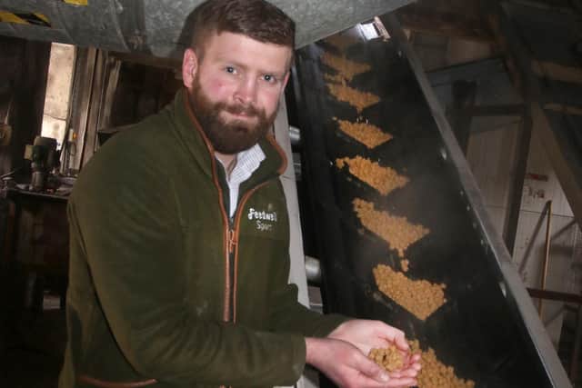 Jamie Clegg checks the wet extruded pellets on their way to the drying chamber. 