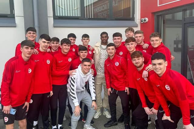 Marcus Rashford with young athletes at the Larne Academy of Sport. (Pic: Larne FC).