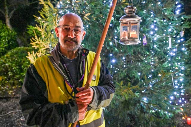 Lead lantern-bearer Brendan McEvoy at the Hospice tree, festooned with messages in memory of lost loved ones.  Photo: Simon Graham Photography