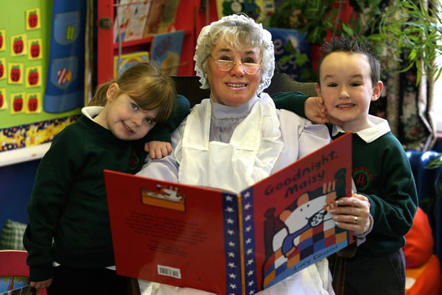 Supervisory Assistant Mrs Ferguson reads a story to P1 Pupils Spencer Allen (4) and Chloe Stewart of Brownlee Primary School, Lisburn, helping promote National Sorytelling Week in 2008