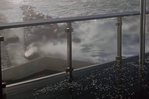The glass-strewn balcony of Portrush Yacht Club's Bay Bar. The Club had been due to host their fundraising RNLI SOS swim. Credit PYC