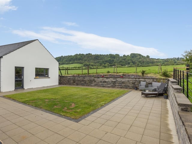Rear garden, finished in lawn and paved patio area.