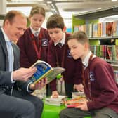 Communities Minister Gordon Lyons talks books with pupils from Largymore Primary School as they celebrate World Book Day at Lisburn Library. Pic credit: Aarom McCracken