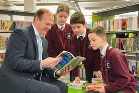 Communities Minister Gordon Lyons talks books with pupils from Largymore Primary School as they celebrate World Book Day at Lisburn Library. Pic credit: Aarom McCracken