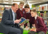 Communities Minister Gordon Lyons talks books with pupils from Largymore Primary School as they celebrate World Book Day at Lisburn Library. Pic credit: Aarom McCracken