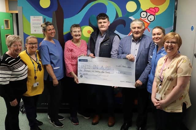 Hazel, David and Barrie Hicks present the cheque to Kate McDowell (Chairperson Paeds in a Pod), Sharon Millar (Hospital Play Specialist), Naomi Heywood (Senior Nursing Assistant), Amy Sellar (Staff Nurse) & Gillian Sinclair (Hospital Play Specialist). Pic credit: SEHSCT